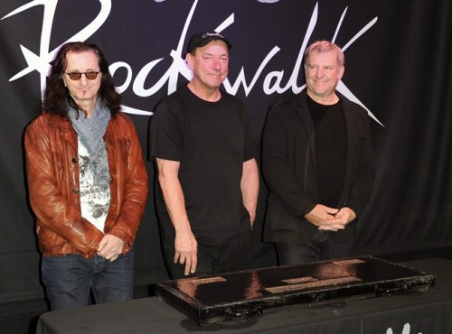 Members of the band Rush, from left, Geddy Lee, Neil Peart, and Alex Lifeson of Rush attend the RockWalk induction of Rush at Guitar Center in Los Angeles, Nov.20, 2012. The members of Rush will be receiving another one of those glittering prizes this weekend: the Allan Waters Humanitarian Award, honouring their decades of dedicated philanthropy. THE CANADIAN PRESS/AP/Photo by Richard Shotwell/Invision/AP