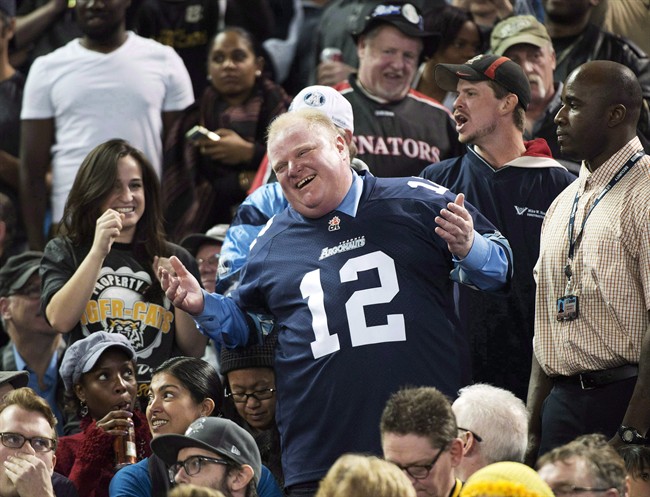 Toronto Mayor Rob Ford laughs with fans as he attends the Toronto Argonauts and Hamilton Tiger-Cats CFL Eastern Conference final football game in Toronto on Sunday, Nov. 17, 2013. Ford was named Canada's Newsmaker of the Year by editors and news directors across the country. The headline-grabbing, sound bite-generating Toronto mayor received 63 per cent of the votes in the annual survey of the country's newsrooms by The Canadian Press. THE CANADIAN PRESS/Nathan Denette