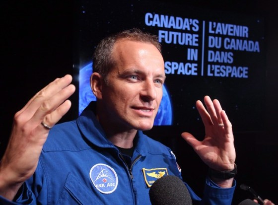 Canadian astronaut David Saint-Jacques speaks to reporters after Industry Minister James Moore announced Canada's commitment to fly two Canadian astronauts to space by 2024 during a news conference in Ottawa Tuesday June 2, 2015. Quebec engineer and doctor Saint-Jacques will be the next Canadian to work in space aboard the International Space Station. THE CANADIAN PRESS/Fred Chartrand
