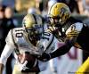 J.P. Moczulski / the canadian press
Hamilton Tiger-Cats defensive back Jerome Dennis tries to bring down Winnipeg Blue Bombers wide receiver Chris Davis.