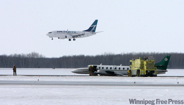 MIKE DEAL / WINNIPEG FREE PRESS ARCHIVES
City firefighters at the scene of the Perimeter Aviation plane’s belly landing at Richardson International Airport March 3.