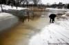 MIKE APORIUS / WINNIPEG FREE PRESS
Erika MacPherson and dog Kiwi look at the rising water of Omand’s Creek in Wolseley Tuesday afternoon. The creek runs into the Assiniboine River.