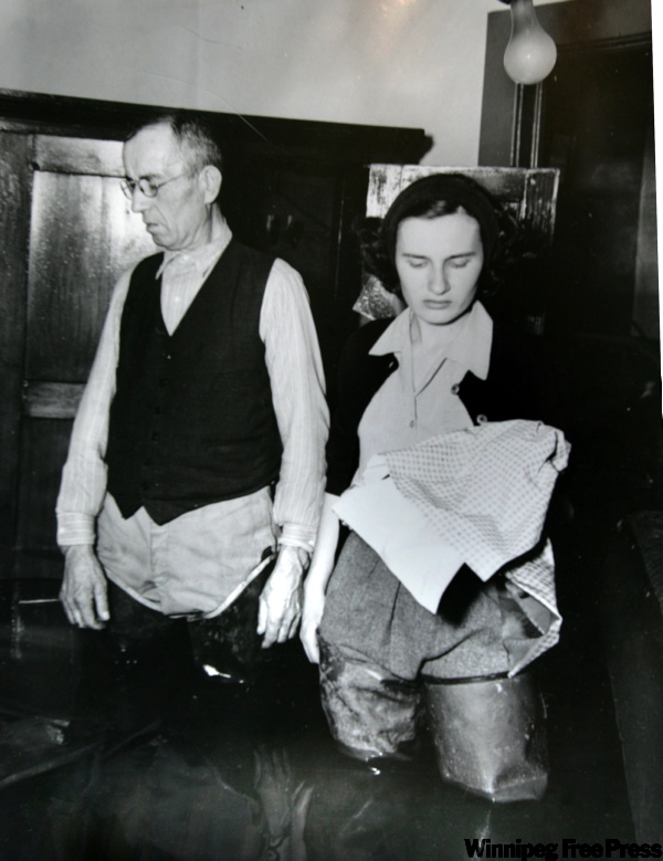 FAMILY PHOTO / WINNIPEG FREE PRESS
Winnipeg Flood Queen Julie Pawluk and her father Peter (Prokop) Pawluk both wearing hip waders in their Rover Avenue family home during the 1950 flood.