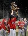 Fernando Salazar / Wichita Eagle
Winnipeg Goldeyes Ace Walker holds up the trophy as the champagne flows after they defeated the Wichita Wingnuts 8-3 to win the American Association Championship in Wichita, Kansas Friday night.