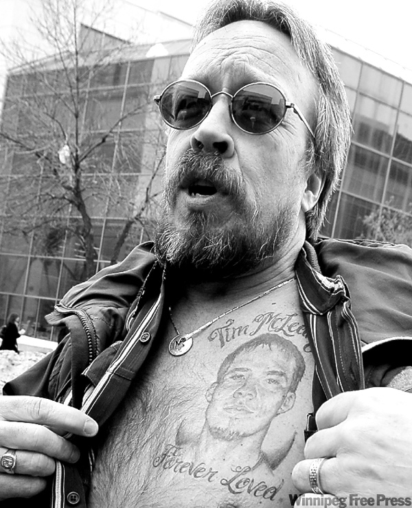 CNS
MIKE APORIUS/WINNIPEG FREE PRESS
Tim McLean Sr. reveals tattoo of son.