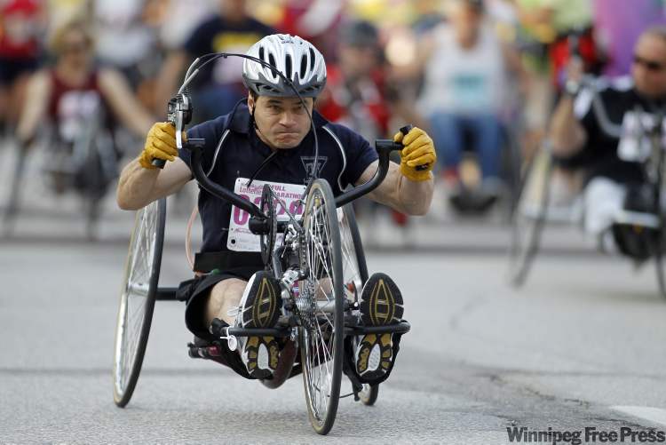 TREVOR HAGAN / WINNIPEG FREE PRESS
A participant in the wheelchair race at the Manitoba Marathon leaves the University of Manitoba this morning.