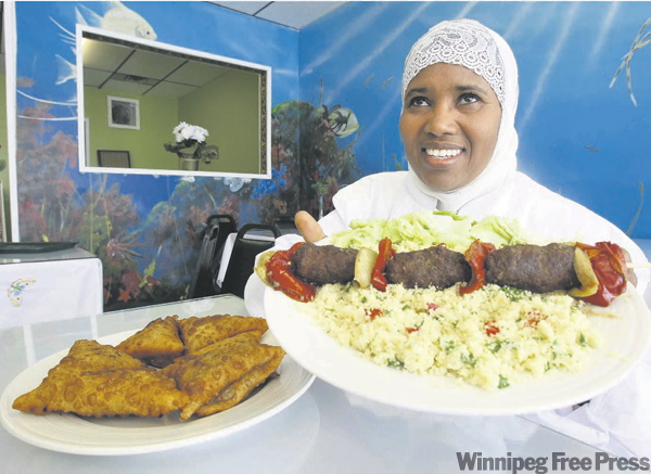 JOE BRYKSA / WINNIPEG FREE PRESS
Owner Roda Guled offers up ground-beef kabob and couscous and homemade samosas.
