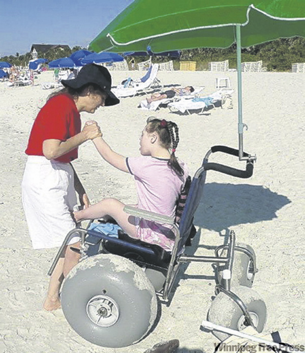 KEVIN ROLLASON / WINNIPEG FREE PRESS
Mary - and others who use wheelchairs - can fully enjoy the beach courtesy of a beach wheelchair.
