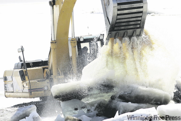 JOHN WOODS / THE CANADIAN PRESS
Busting up the shoreline ice has paid off as the floodway is now working at full efficiency.