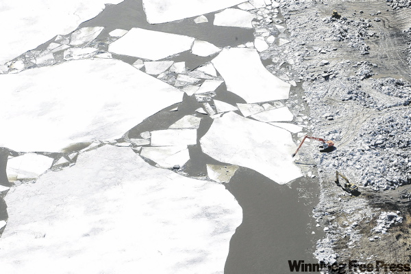 Joe Bryksa / Winnipeg Free Press
Heavy equipment used to break up ice near the floodway entrance looks like toys compared to the massive floes.