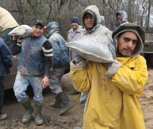 JOE BRYKSA / WINNIPEG FREE PRESS archives
When the 2011 Assiniboine River flood halted an asparagus harvest near Portage la Prairie, migrant workers from Mexico helped out sandbagging.