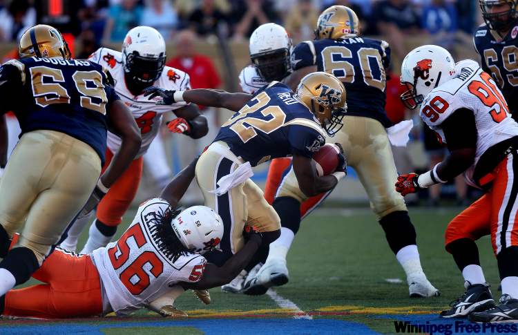 PHIL HOSSACK/ WINNIPEG FREE PRESS
B.C. Lions players close in on Winnipeg's Fred Reid on Thursday night.