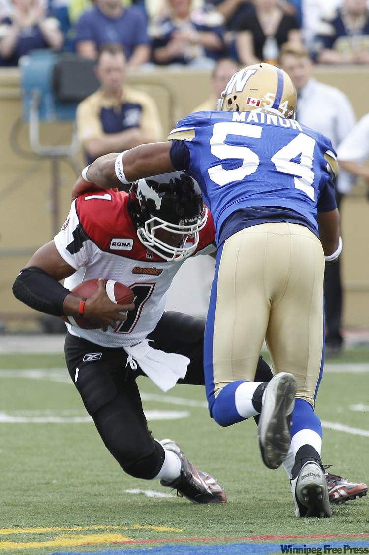 John Woods / Winnipeg Free Press
Blue Bombers' Kenny Mainor (54) sacks Calgary Stampeders quarterback Henry Burris Thursday night.