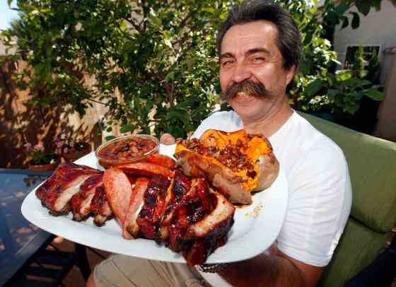 Smoking Hawg's Bernie Lutzer will be defending his title as the festival's barbecue grand champion.