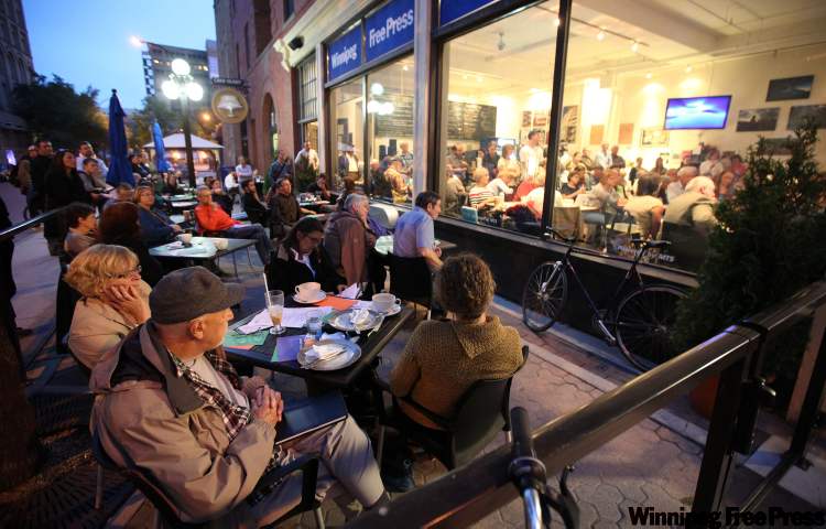 Phil Hossack / Winnipeg Free Press
Overflow participants watch a candidates debate from the patio at the Free Press News Cafe in September. The cafe will be