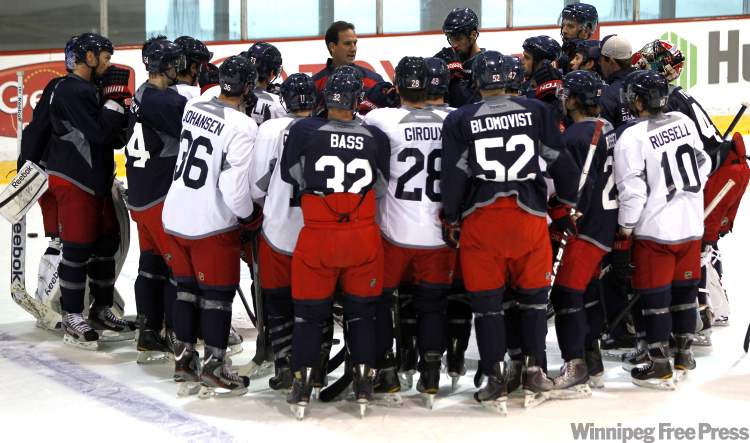 Boris Minkevich/ Winnipeg Free Press
The Blue Jackets gather around coach Scott Arniel Tuesday morning during practice in Columbus.