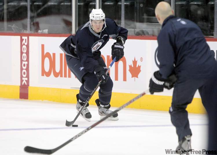 MIKE DEAL / WINNIPEG FREE PRESS
Rookie hopeful Mark Scheifele gets ready to put a deke on assistant coach Charlie Huddy during Thursday's practice.