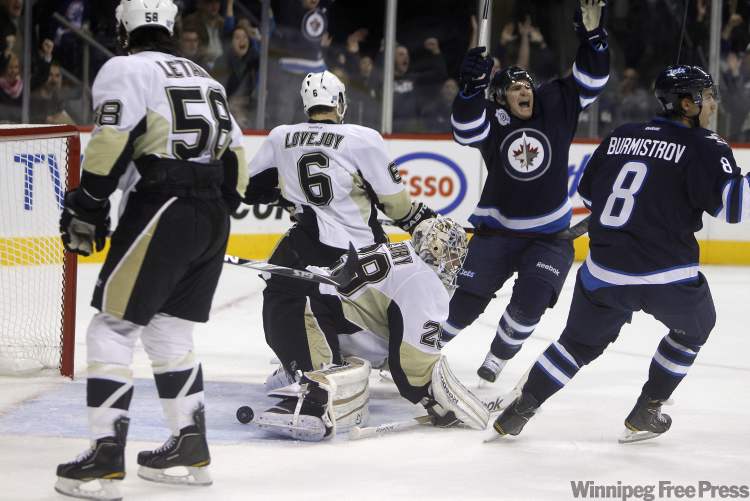 TREVOR HAGAN/WINNIPEG FREE PRESS
Jim Slater and Alexander Burmistrov celebrate the Jets second goal.