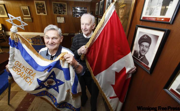 ruth bonneville / winnipeg free press
Morris Faintuch (left) and Israel Yamron standing next to the Wall of Fame war veteran photos at the Jewish Legion on Main Street.