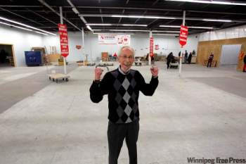 photos by BORIS MINKEVICH / WINNIPEG FREE PRESS
People with an empty feeling usually don't look this happy, but Kai Madsen has good reason to be filled with joy. All the hampers at the Christmas Cheer Board warehouse have been delivered.