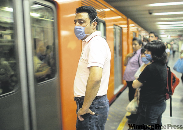 CP
MIGUEL TOVAR / THE ASSOCIATED PRESS
Commuters wear masks waiting for a subway train in Mexico City Friday.