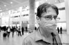 CNS
Merle Robillard / Canwest News Service
Paulino Lozada arrives at Pearson International Airport in Toronto Sunday wearing a surgical mask after a trip to Mexico.