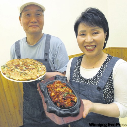 BORIS.MINKEVICH@FREEPRESS.MB.CA 
Seok Geon Kim, left, and Myung Ja Baek with Haimool Pajun and chicken bulgogi.