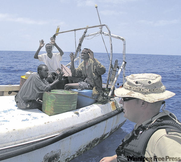 DAN LETT / WINNIPEG FREE PRESS
HMCS Winnipeg crew member detains three suspected pirates on Sunday in the Gulf of Aden, 80 kilometres south of the Yemen coast.
