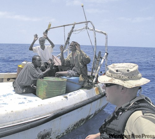 DAN LETT / WINNIPEG FREE PRESS
HMCS Winnipeg crew member detains three suspected pirates on Sunday in the Gulf of Aden, 80 kilometres south of the Yemen coast.