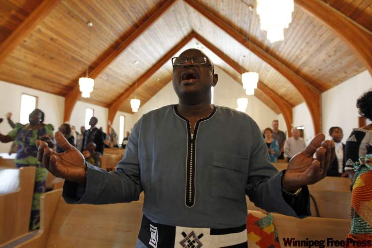TREVOR HAGAN / WINNIPEG FREE PRESS
Rev. Joseph Seidu sings and sways during services at Crestview Park Free Methodist on a recent Sunday. Lindor Reynolds visited the small St. James house of worship that is home to many newcomers.