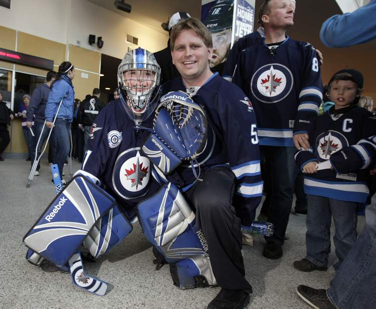 TREVOR HAGAN / WINNIPEG FREE PRESS
Cody Creasy, 8, with his dad, Shaun, from Brandon believe the Winnipeg Jets will make the playoffs, and Cody is ready to help out.