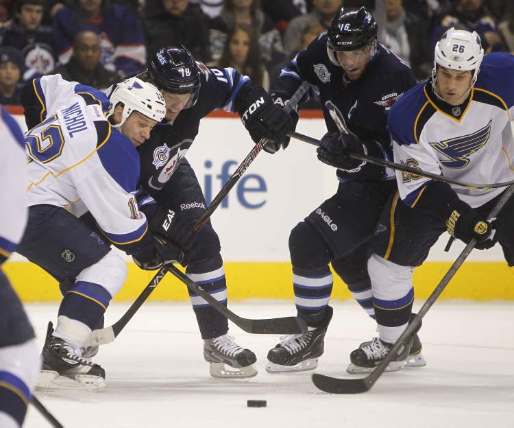 TREVOR HAGAN / WINNIPEG FREE PRESS
The Winnipeg Jets' Bryan Little (18) and Andrew Ladd (16) battle for the puck between the St. Louis Blues' Scott Nichol (12) and B.J. Crombeen (26) during second period NHL action at the MTS Centre, Saturday.