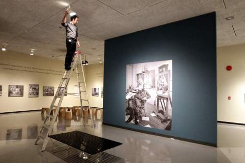 Mike Deal / Winnipeg Free Press
Radovan Radulovic, head of conservation, points a spotlight at a photograph of Norman Rockwell. The Winnipeg Art Gallery saw a huge turnout for its spring blockbuster, American Chronicles: The Art of Norman Rockwell.