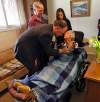 Dr. Sawchuk listens to Theresa Miller's heart during home visit. From left: Dr. Paul Sawchuk,  husband Don Miller, case co-ordinator Arle Jones, Theresa Miller.