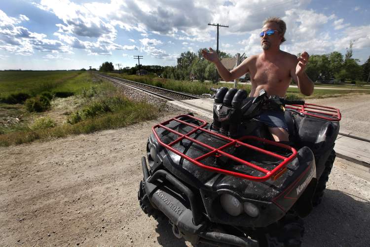 JOHN WOODS / WINNIPEG FREE PRESS
Barry Sigurdson sits at the crossing where he witnessed a pickup truck run into a CN freight train west of Anola early Sunday morning.