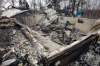 KEN GIGLIOTTI / WINNIPEG FREE PRESS
Two houses in Vita on Winchester Drive that were destroyed by wildfires. At far right Margaretha and (far left) Jacob  Martens, with their family members, inspect their totally destroyed home.