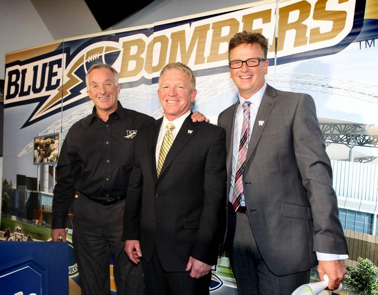 RUTH BONNEVILLE / WINNIPEG FREE PRESS
Tim Burke is all smiles after press conference at the Blue Bomber office Thursday afternoon after being officially announced the 29th head coach of the Winnipeg Blue Bombers by team President and CEO Garth Buchko (right) and GM Joe Black.