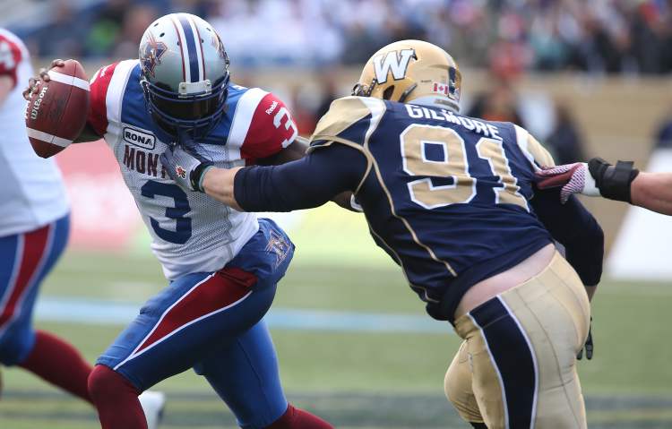 TREVOR HAGAN / WINNIPEG FREE PRESS
Montreal Alouettes' quarterback Adrian McPherson (3) is grabbed by Winnipeg Blue Bombers' JT Gilmore (91) during the first half of CFL action in the final game at Canad Inns Stadium, Saturday.
