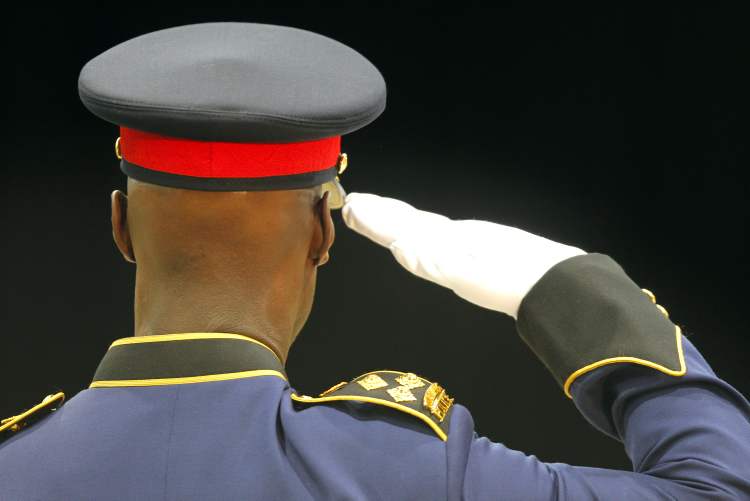 BORIS MINKEVICH / WINNIPEG FREE PRESS archives
Police Chief Devon Clunis salutes police academy grads last year. A draft of a review of police operations proposes deep cuts.