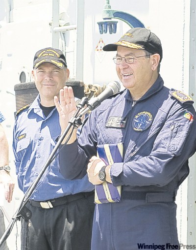 RICK AYER / FORMATION IMAGING SERVICE
Rear-Admiral Jose Domingos Pereira da Cunha (right) commends Cmdr. Craig Baines and crew.