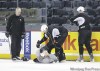 MIKE.APORIUS@FREEPRESS.MB.CA 
Assistant coach Jay Wells watches as Pierre-Sedric Labrie (centre) and Taylor Ellington tag-team Tommy Maxwell on Thursday.