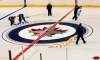 Ruth Bonneville /  Winnipeg Free Press
Ice technicians lay out the logos for the Jets at centre ice at the MTS Centre this morning in preparation for the start of the shortened NHL season.