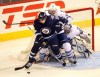 Phil Hossack / Winnipeg Free Press Archives
Winnipeg Jet Antti Miettinen works against Maple Leaf defenceman Michael Kosta and netminder James Reimer March 13 at the MTS Centre. The Leafs host the Jets Saturday night.