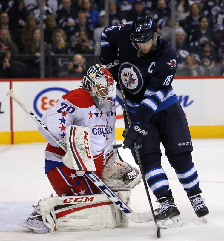 Phil Hossack / Winnipeg Free Press archives
Winnipeg Jets Captain Andrew Ladd battles with Washington Capitals goalie Braden Holtby in a game at the MTS Centre in March. Both Ladd and Holtby are contenders to play on Team Canada.