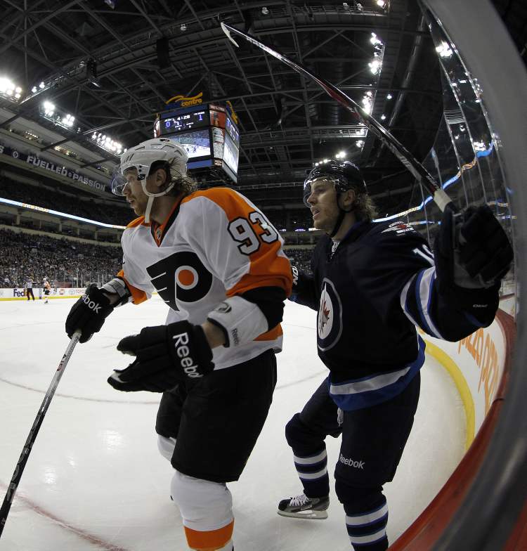TREVOR HAGAN / WINNIPEG FREE PRESS
Philadelphia Flyers Jakub Voracek (93) battles with Winnipeg Jets' Bryan Little (18) during the first period of NHL action at MTS Centre in Winnipeg, Saturday.