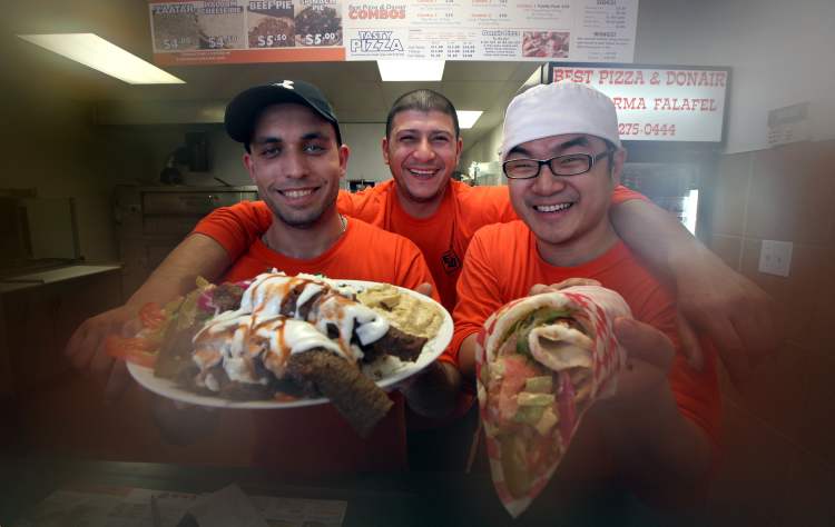 Phil Hossack / Winnipeg Free Press
Left to right, Loai Assaf, Taz Adel and Yenu Li will be happy to serve up a donair platter and a chicken shawarma (right) at Best Pizza & Donair.