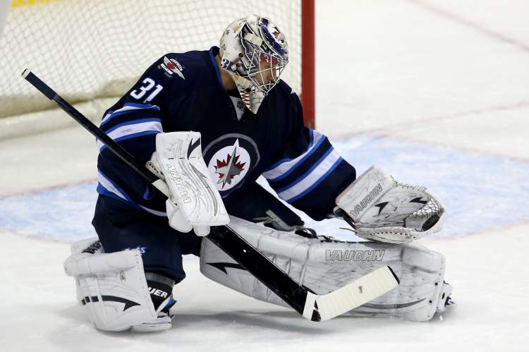 TREVOR HAGAN / WINNIPEG FREE PRESS Archives
Winnipeg Jets' goaltender Ondrej Pavelec (31) makes a glove save against the New York Islanders' during first period NHL action at MTS Centre in Winnipeg, April 20. Pavelec's ability has helped get the Jets to where they are, but he needs to be even better.