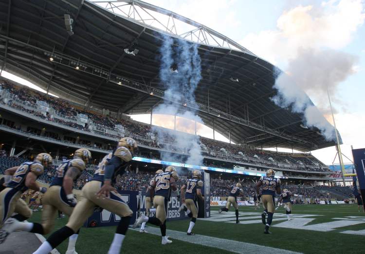 Joe Bryksa / Winnipeg Free Press
The revved-up Winnipeg Blue Bombers sprint onto the field for their first taste of real action at Investors Group Field on Wednesday night.