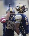 (JOE BRYKSA / WINNIPEG FREE PRESS
Winnipeg Bombers Chris Matthews, right, celebrates Bombers' first ever touchdown in new stadium with teammate Jade Etienne.