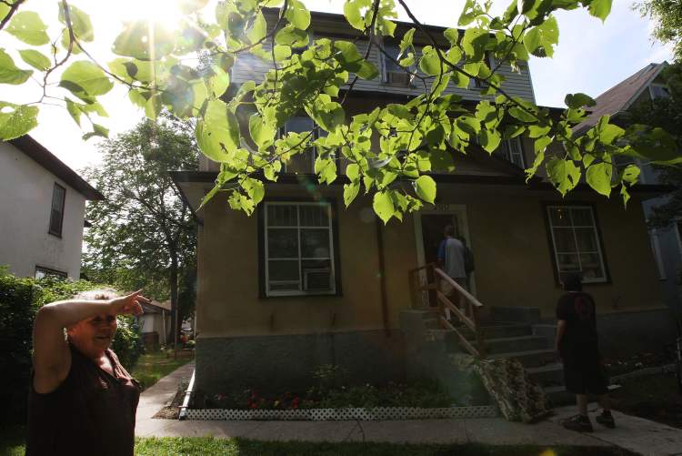 Joe Bryksa / Winnipeg Free Press
Veteran tenant Cathy stands outside the Furby Street rooming house where she rents a suite on the third floor.